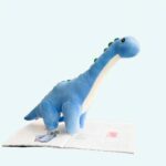 Blue dinosaur plush in a living room on a table