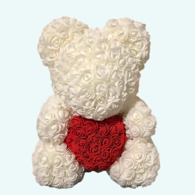 Teddy bear white roses collector's box on a light blue background.