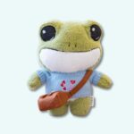 Frog plush with jumper on a light blue background.