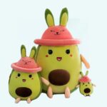 Cute avocado plush with hat on a light blue background.