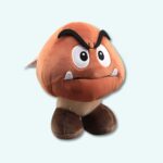 Evil mushroom plush super mario on a light blue background.