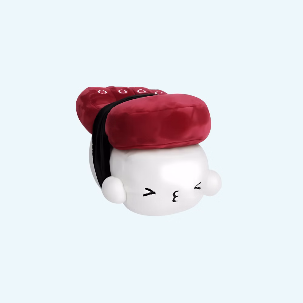 Img_01_25_Peluche_Coussin_Sushi_Calamar_Kawaii_1.Jpg Pillow plush shaped like a squid sushi, in Kawaii style. The white base represents rice with a smiling, expressive face, topped with a burgundy piece mimicking squid. A black fabric band suggests the seaweed wrapping the whole piece.
