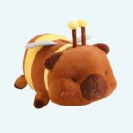 Capybara plush dressed as a bee on a white background