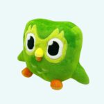 Green Duolingo Plush – Duo, three-quarter view on light blue background