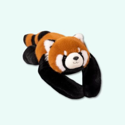 Weighted raccoon plush with brown and black fur, lying on its belly, against a sky blue background.