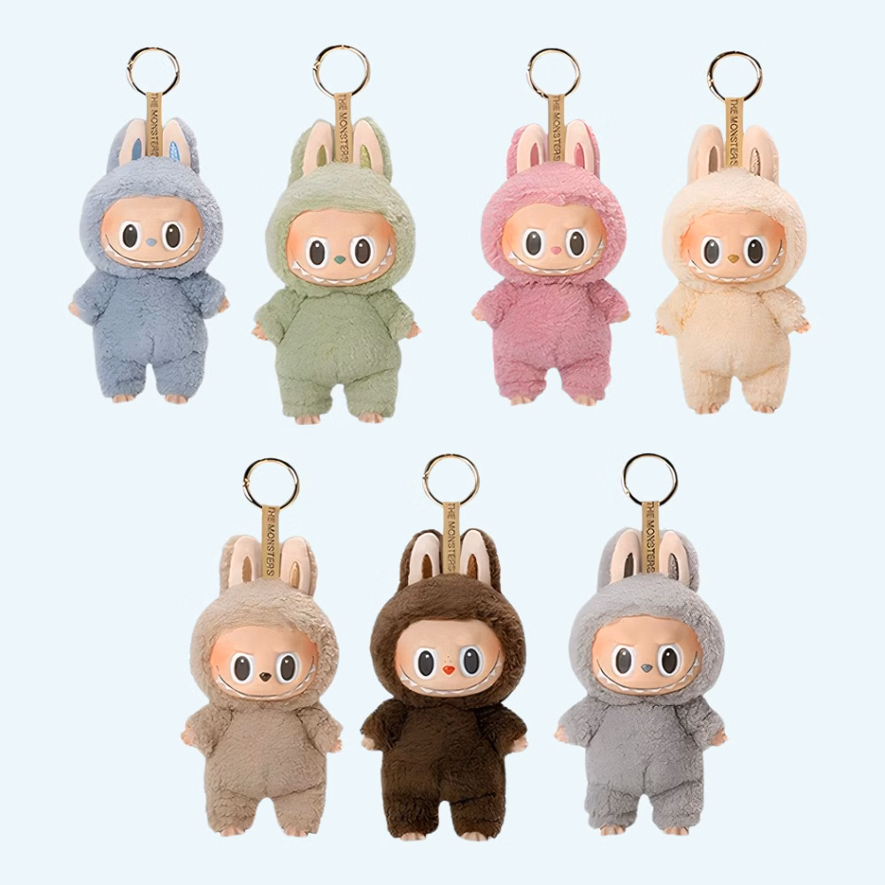 Img_09_2025_Peluche_Porte-Clef_Style_Labubu_1.Jpg Labubu-inspired plush keychains in various colors on a sky blue background